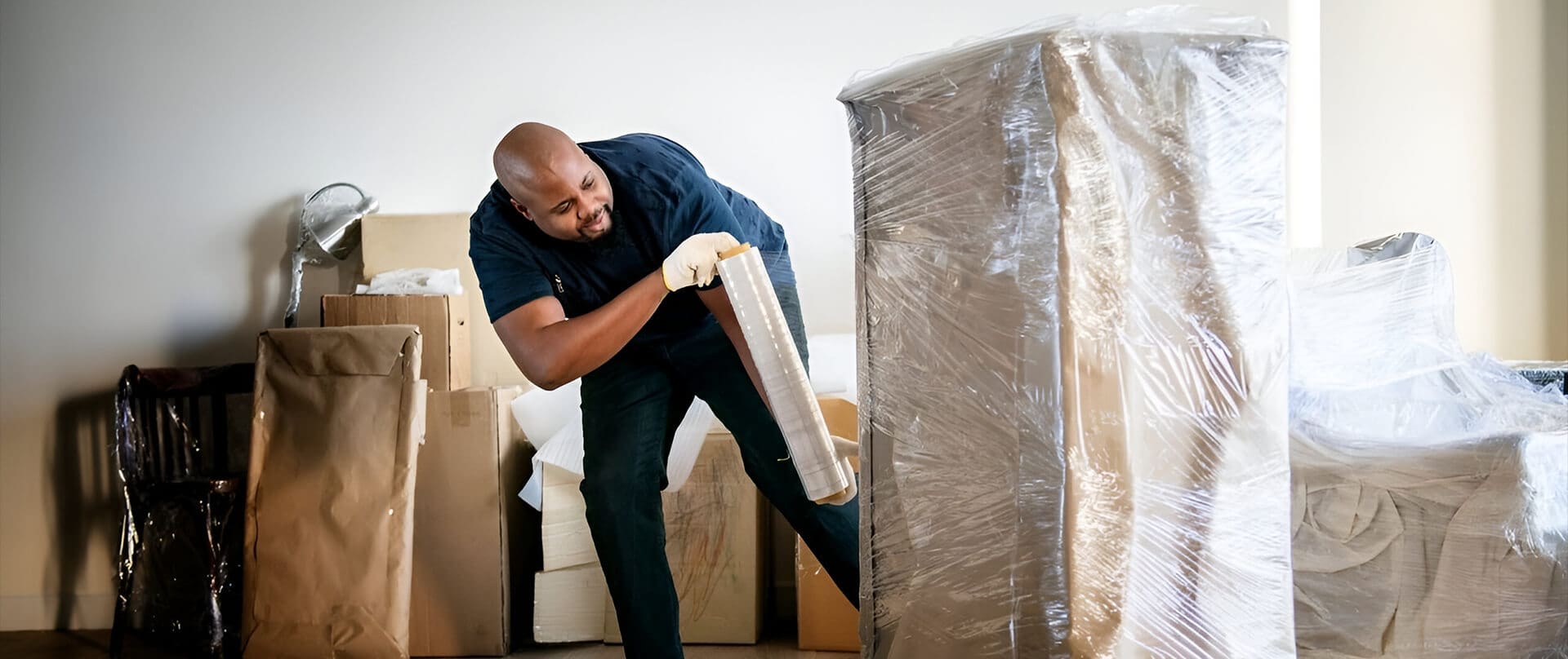 A man is moving furniture in the house