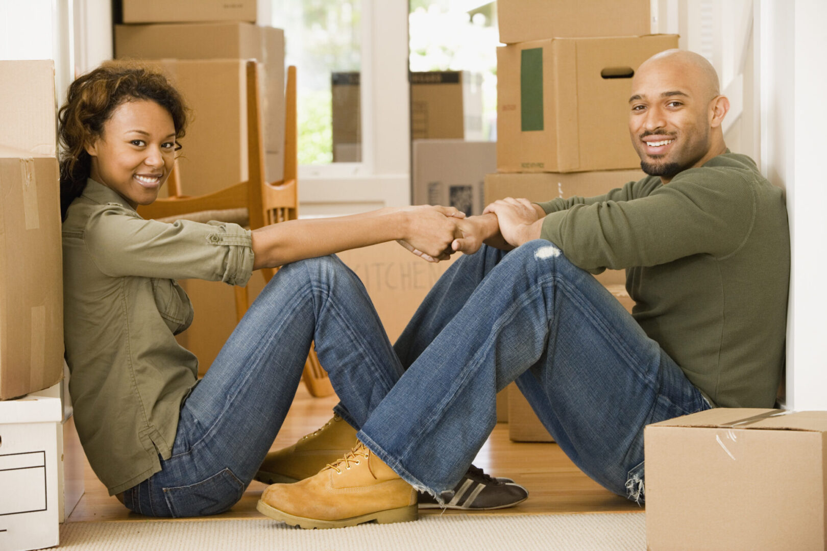 Two men sitting on the floor in a room