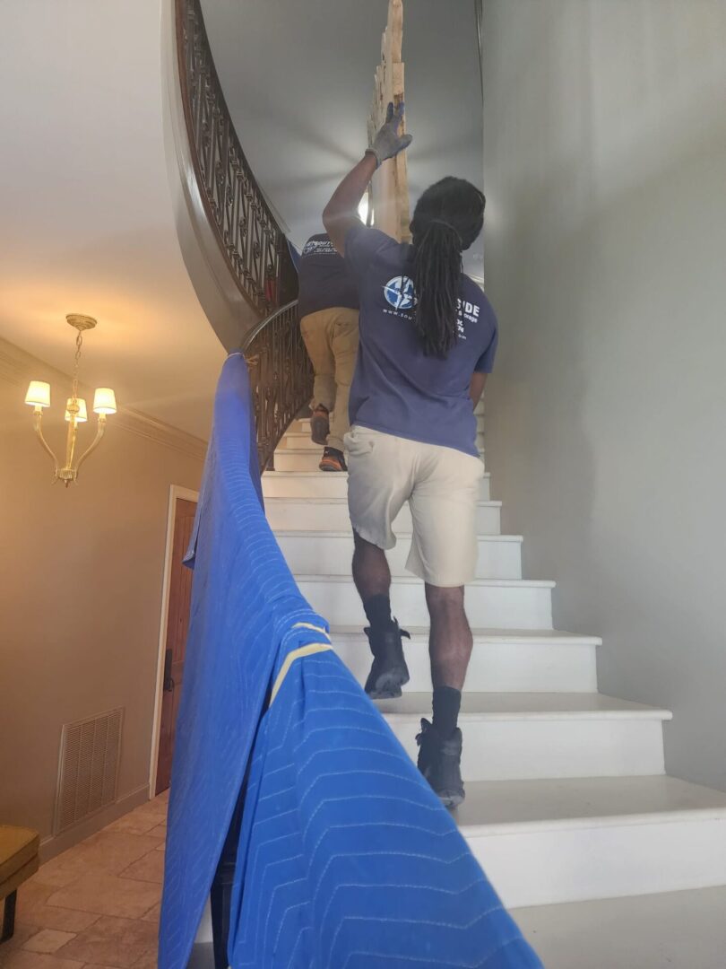 A man and his dog are climbing up the stairs.