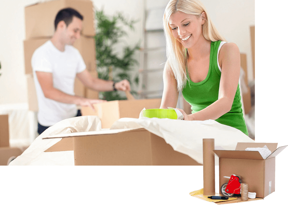 A woman and man packing boxes in a room.