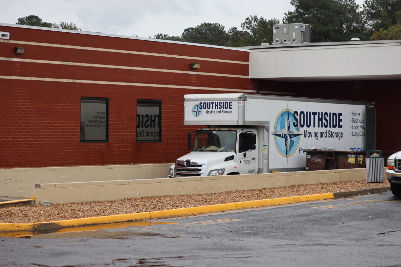 A white truck parked in front of a building.