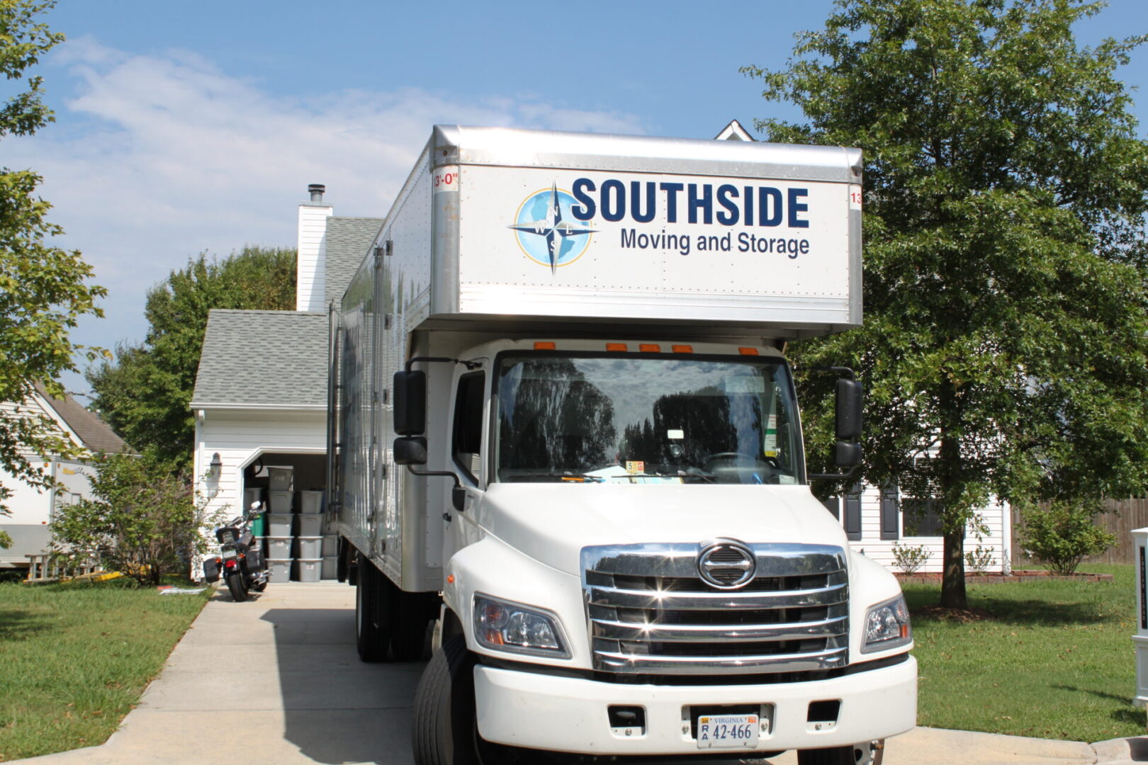 A white truck is parked in front of a house.