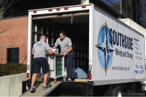 Two men unloading a moving truck from the back.