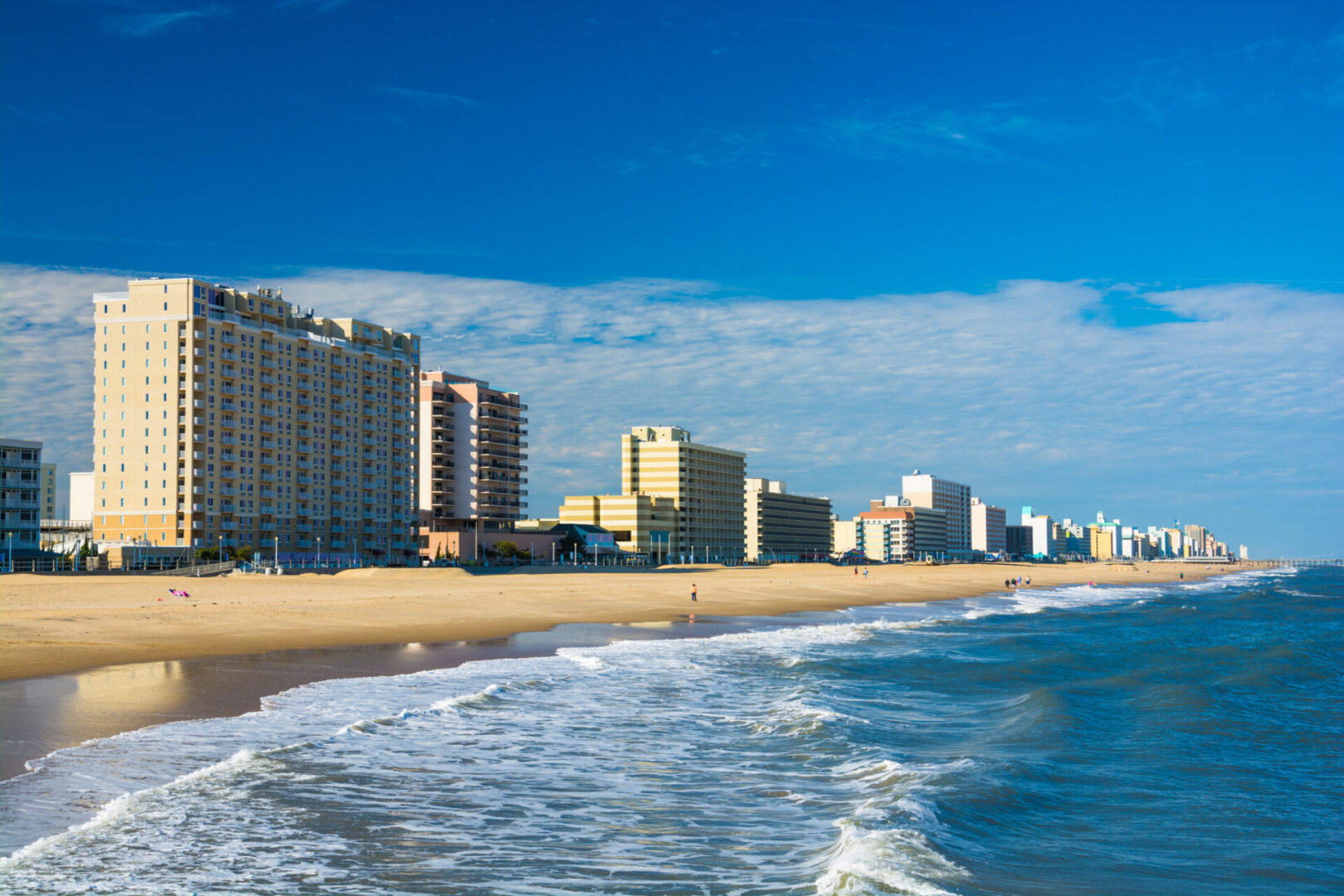 A beach with many buildings on the side of it