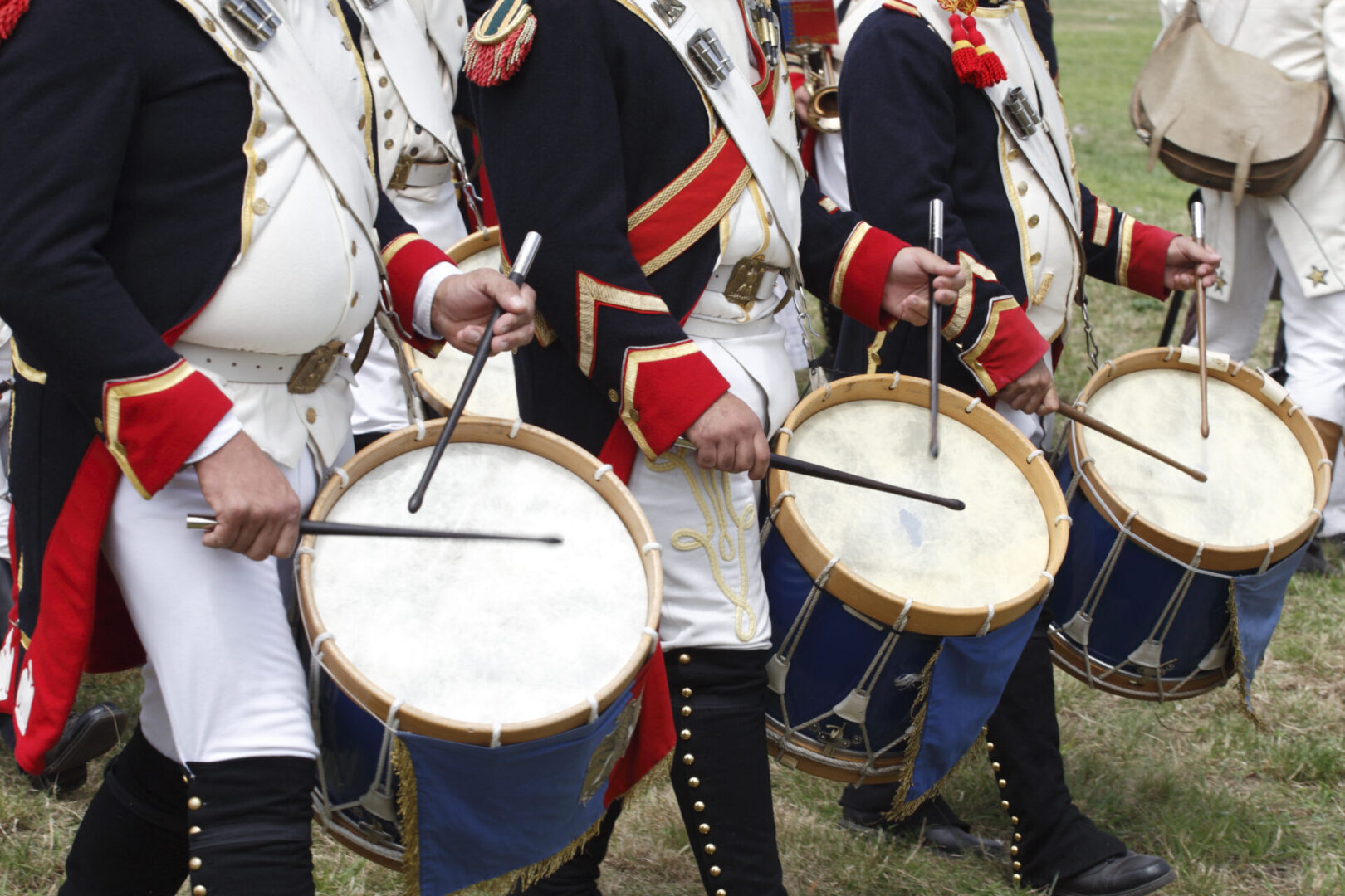 A group of men in uniforms playing drums.