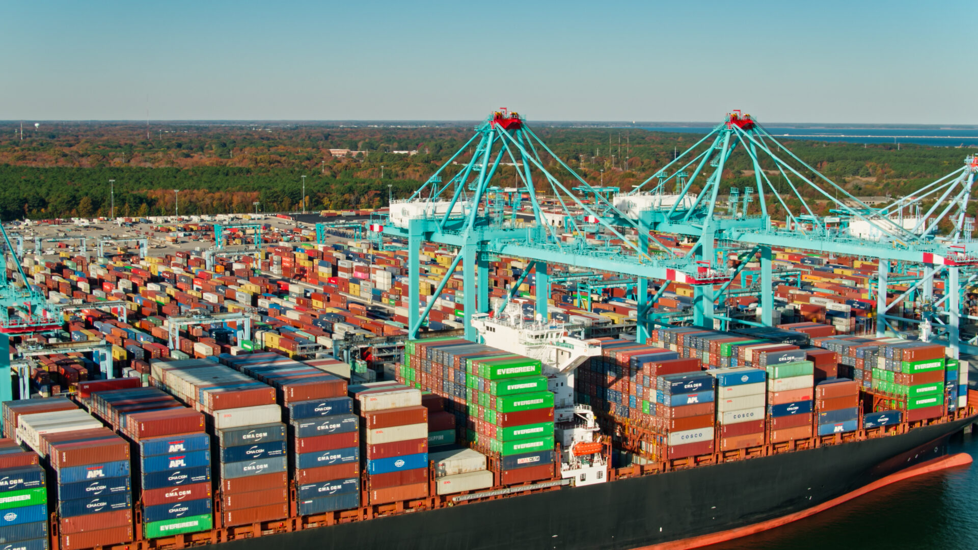 A large cargo ship in the ocean with many containers.