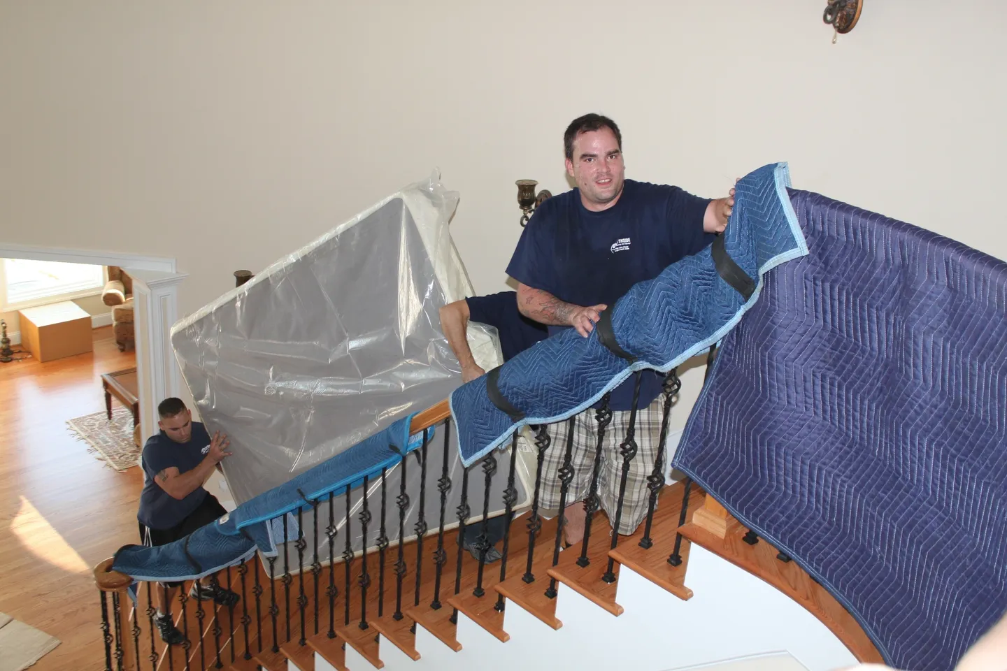 A man is moving furniture down the stairs.