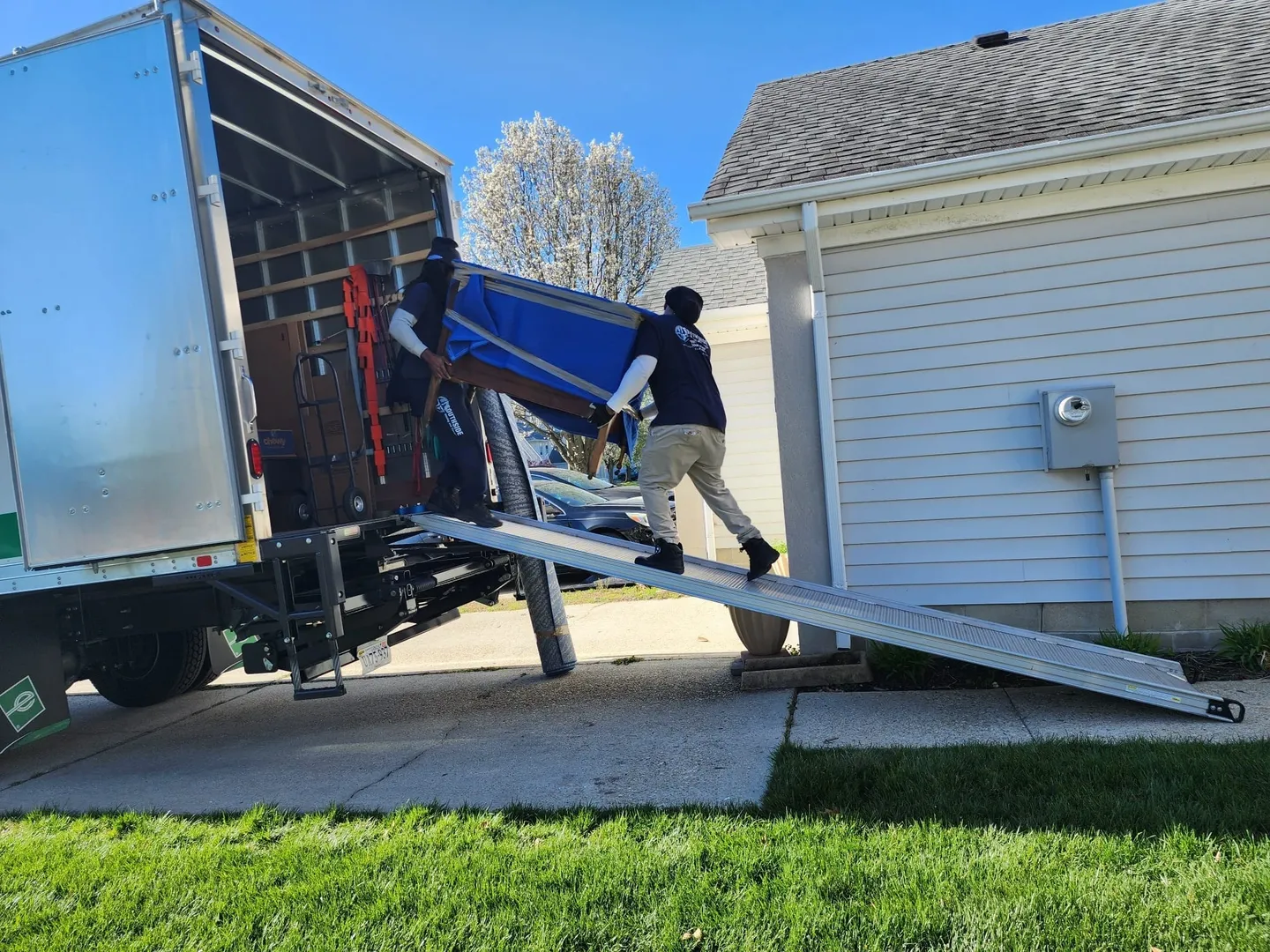 A man is loading furniture onto the back of a truck.