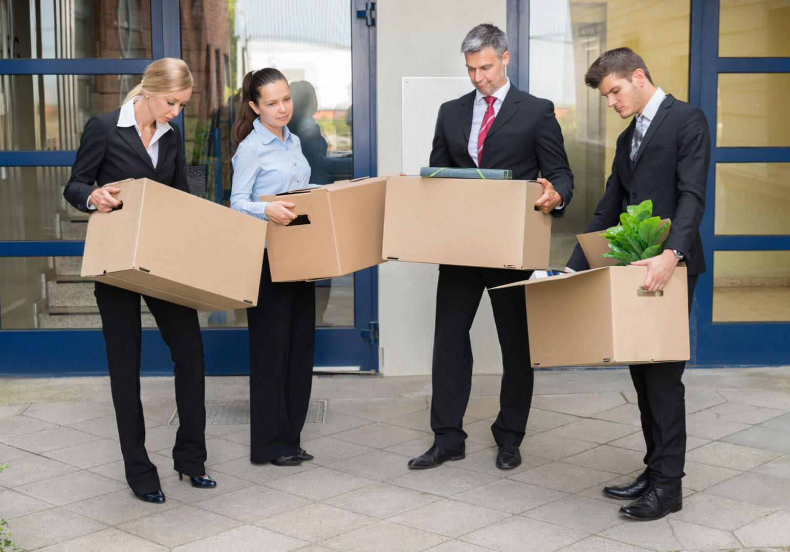 A group of people holding boxes in front of them.