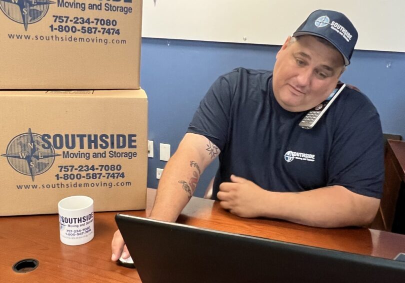 A man sitting at his desk with boxes in front of him.