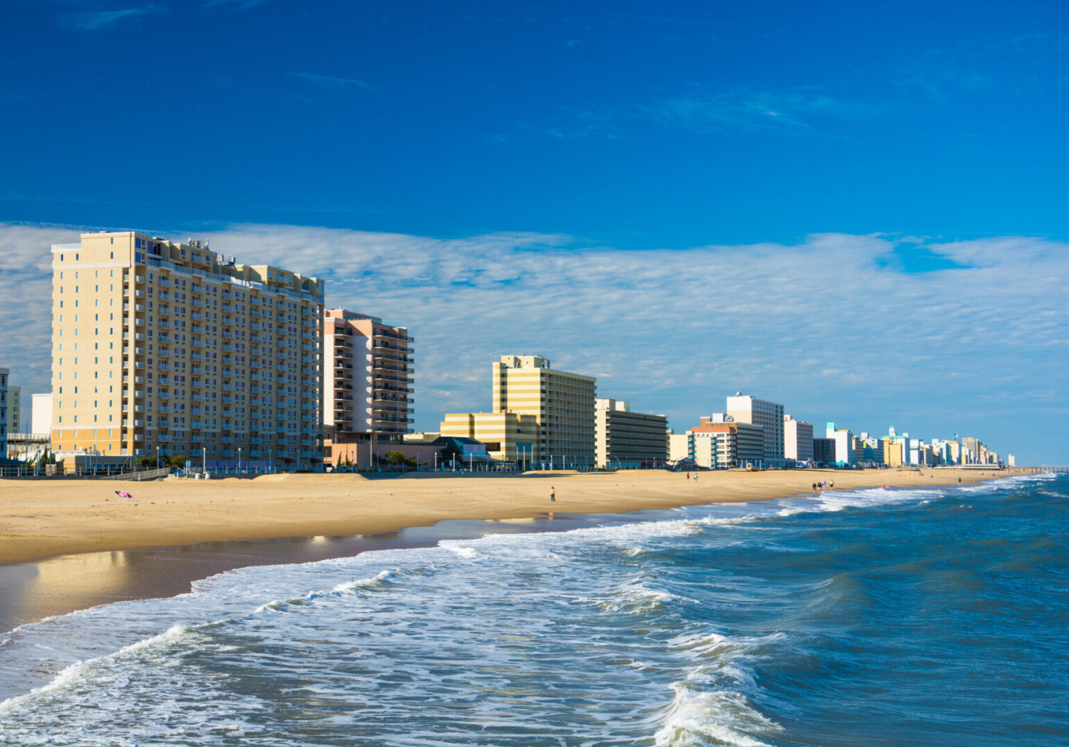 A beach with many buildings on the side of it